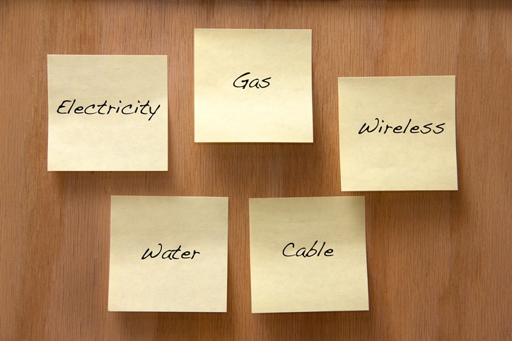 Home expenses listed on sticky notes on a wooden board